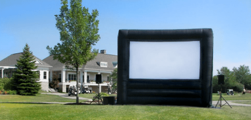 A large inflatable screen in the middle of a lawn.