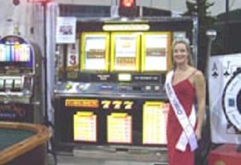 A woman in red dress standing next to slot machine.