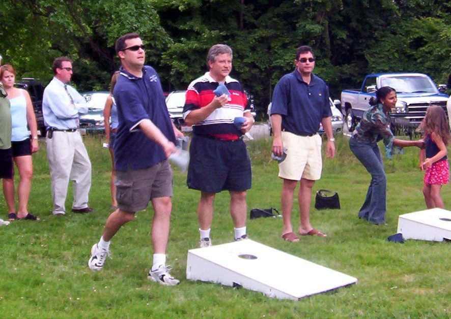 A group of men playing a game on the grass.