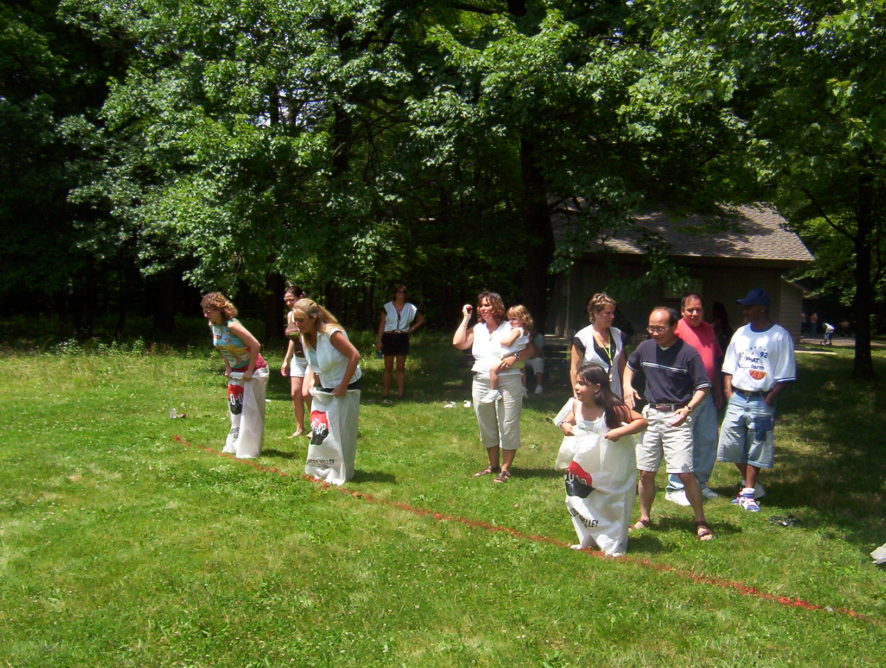 A group of people standing in the grass.