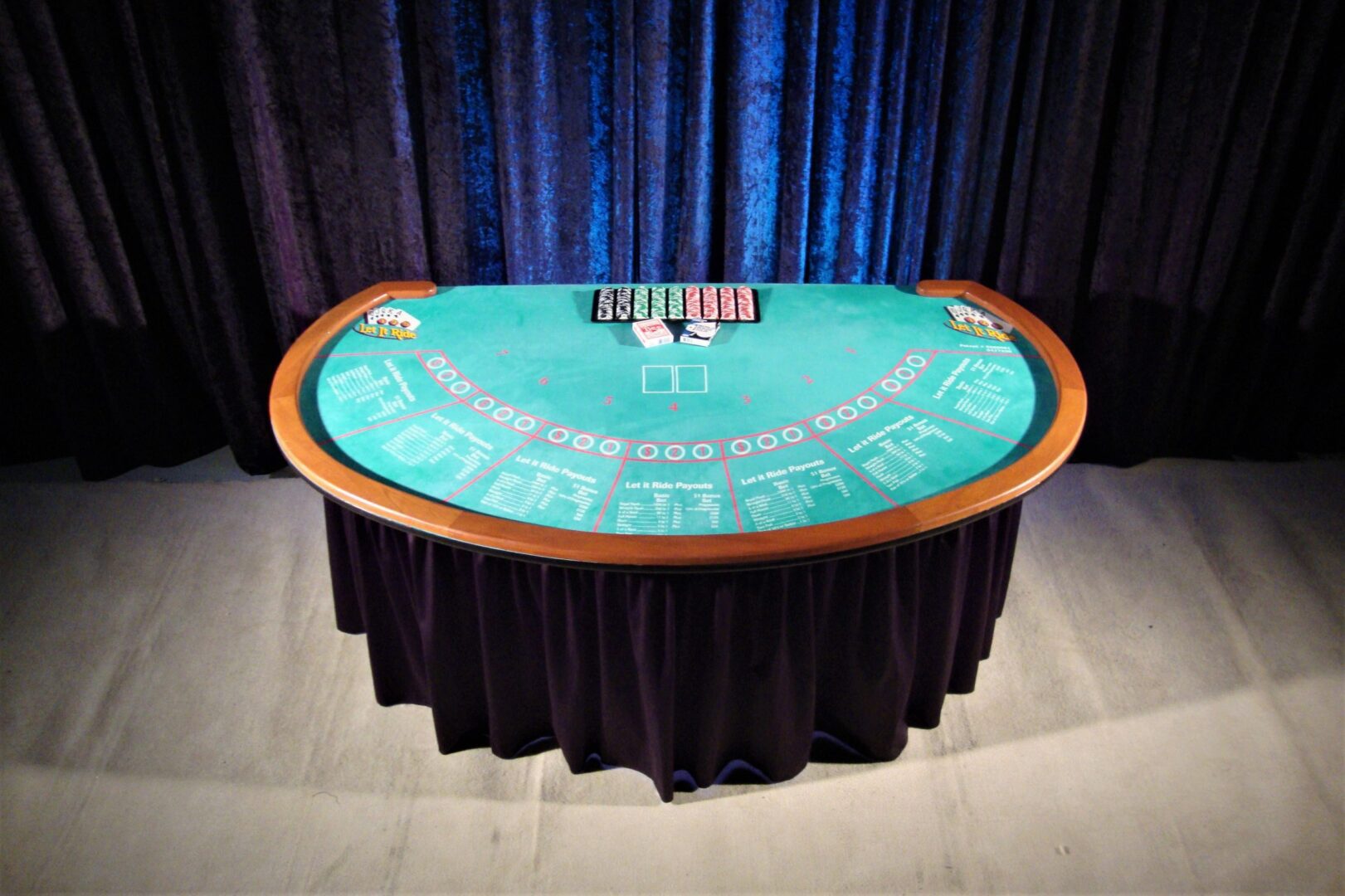 A casino table with a deck of cards on it.